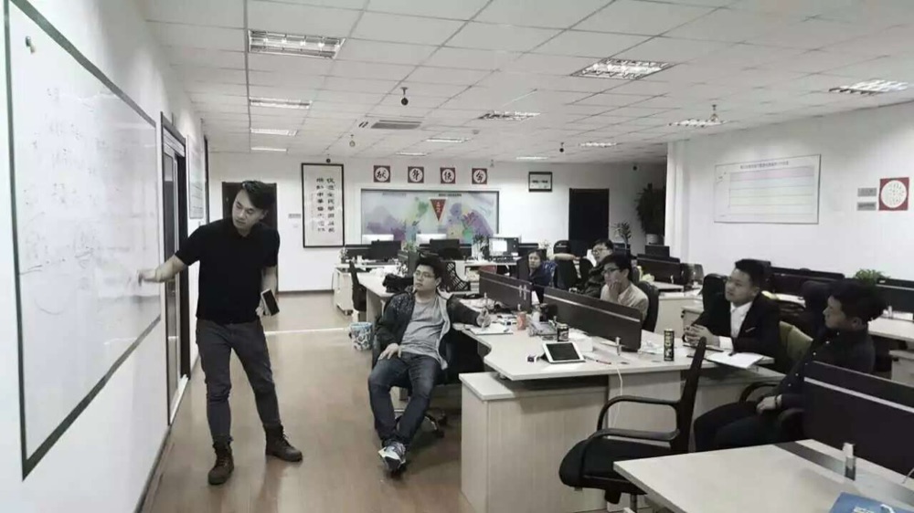 Derek at a whiteboard with the early PatPatPark team