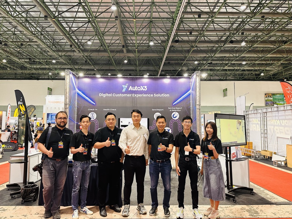 The AutoX3 team on the exhibition stand